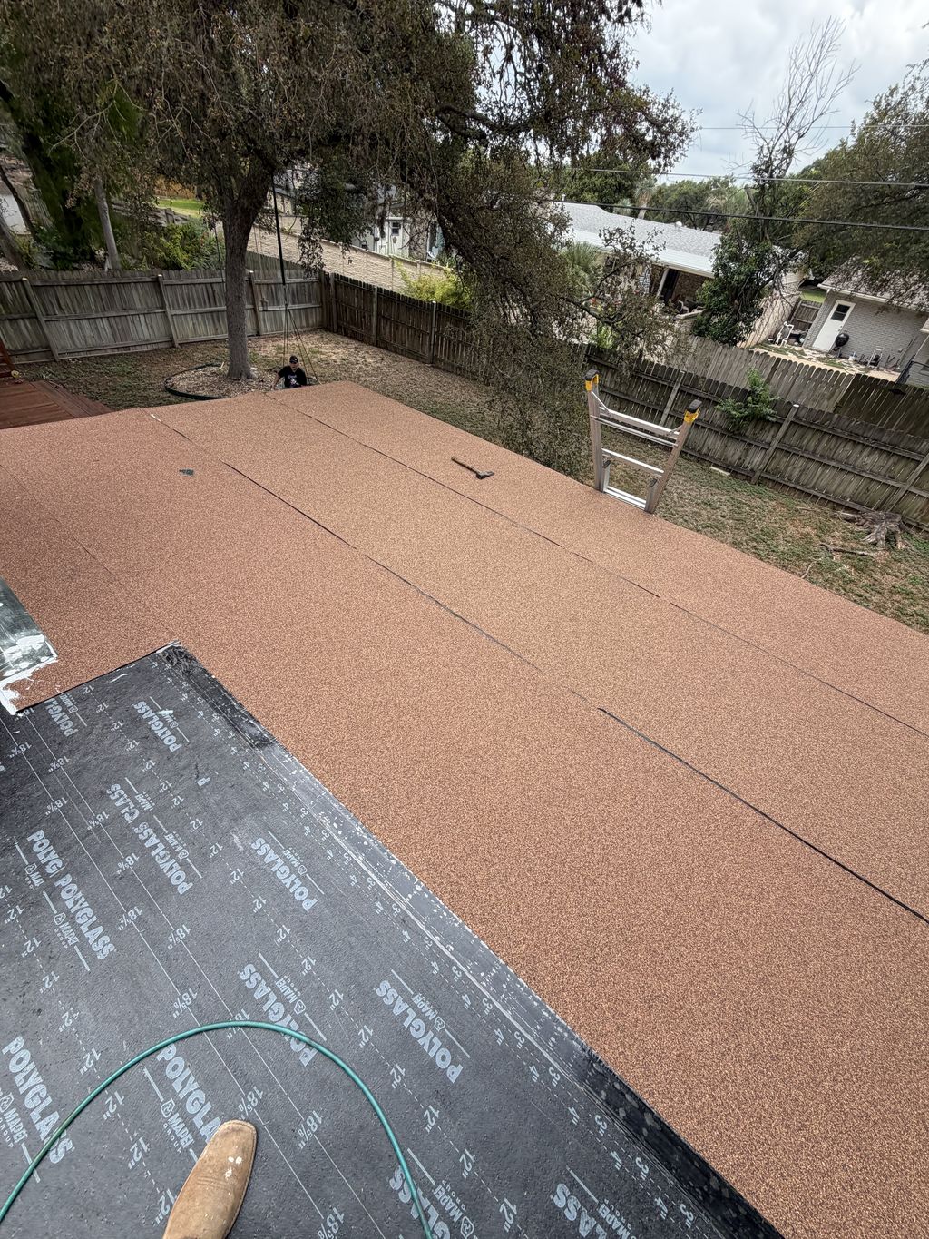 New modified bitumen cap sheet installed over a low-slope patio roof in San Antonio